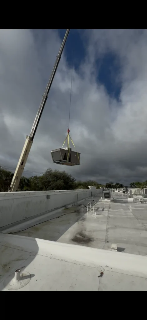 HVAC unit lifted onto a rooftop